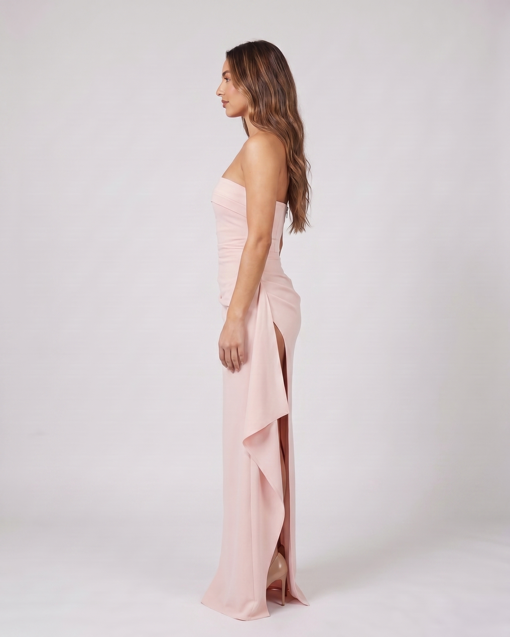 Side view of pink strapless ruched thigh split maxi dress