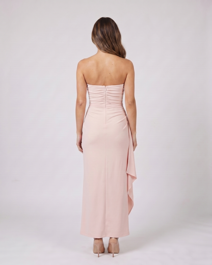 Back view of pink strapless ruched thigh split maxi dress showing solid back with center back zipper closure