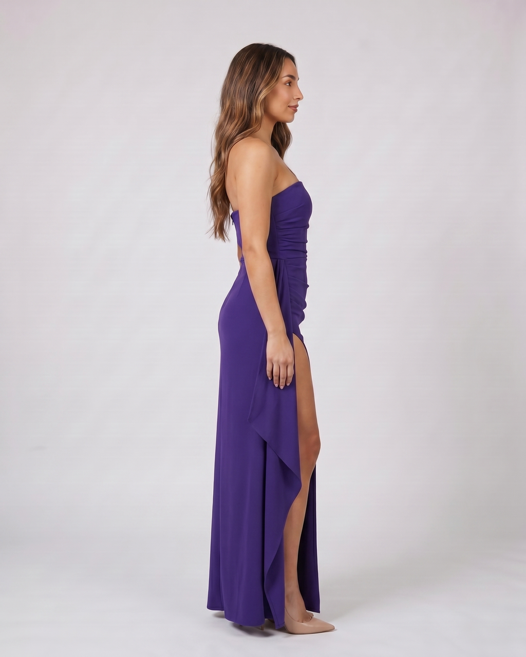 Side view of purple strapless ruched thigh split maxi dress