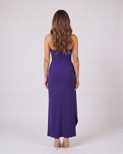 Back view of purple strapless ruched thigh split maxi dress showing solid back with center back zipper closure