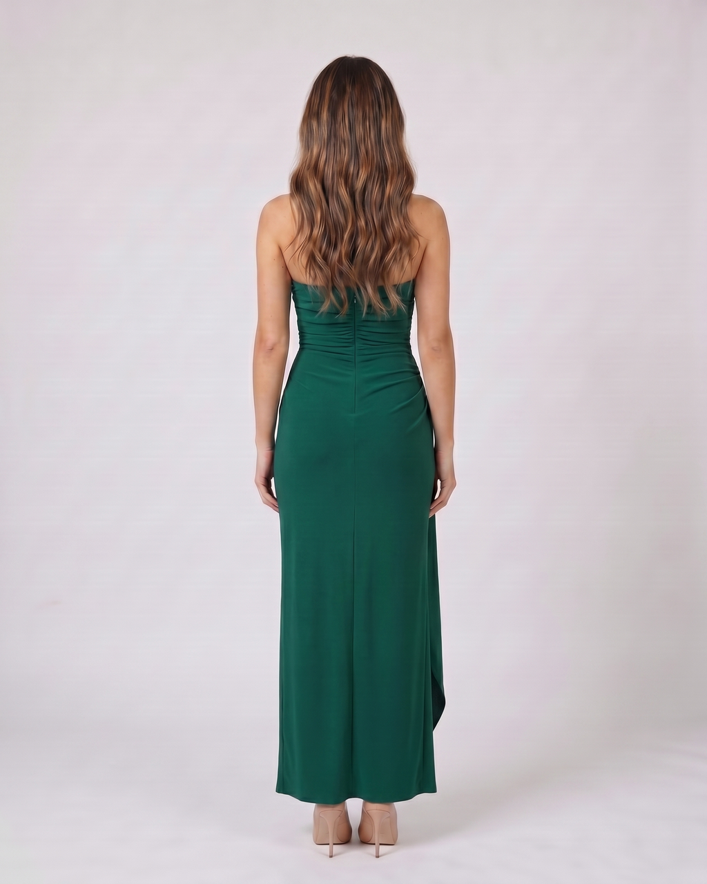 Back view of green strapless ruched thigh split maxi dress showing solid back with center back zipper closure