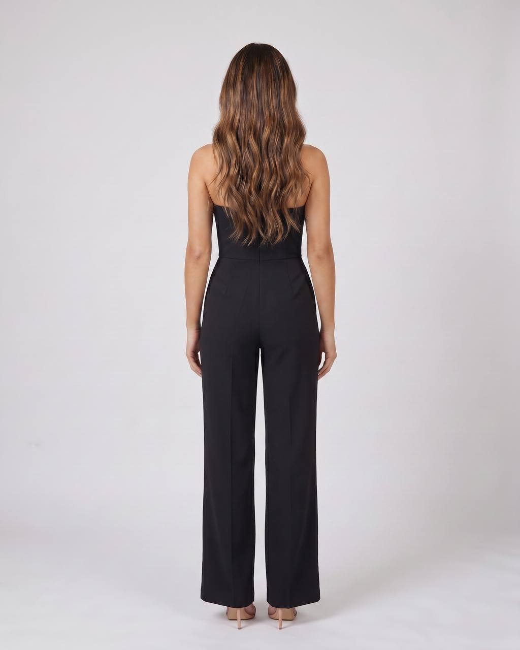 Back view of black strapless sweetheart wide leg formal jumpsuit showing not visible