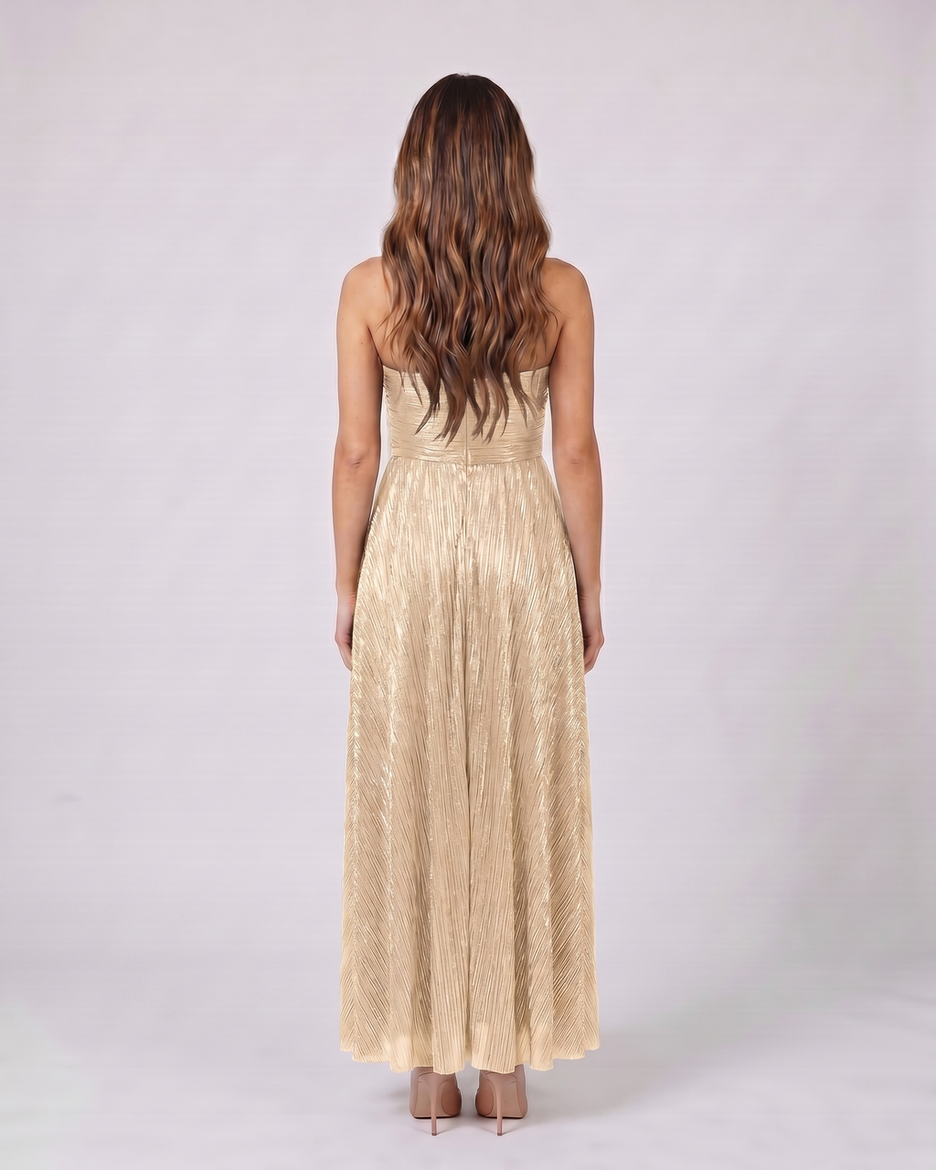 Back view of champagne strapless twist front keyhole maxi dress showing solid back