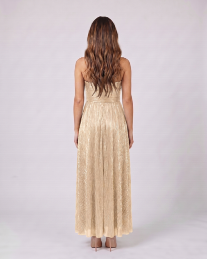 Back view of champagne strapless twist front keyhole maxi dress showing solid back