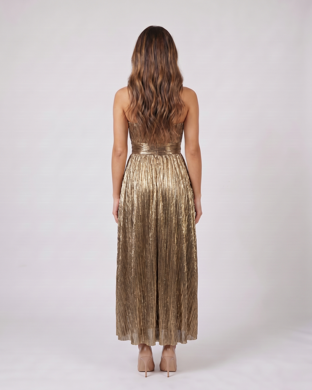 Back view of gold strapless twist front keyhole maxi dress showing solid back