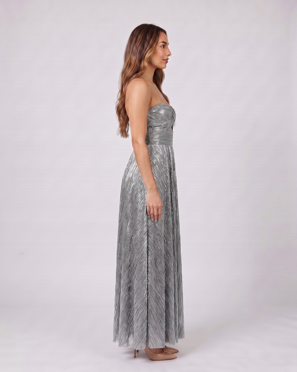 Side view of silver strapless twist front keyhole maxi dress