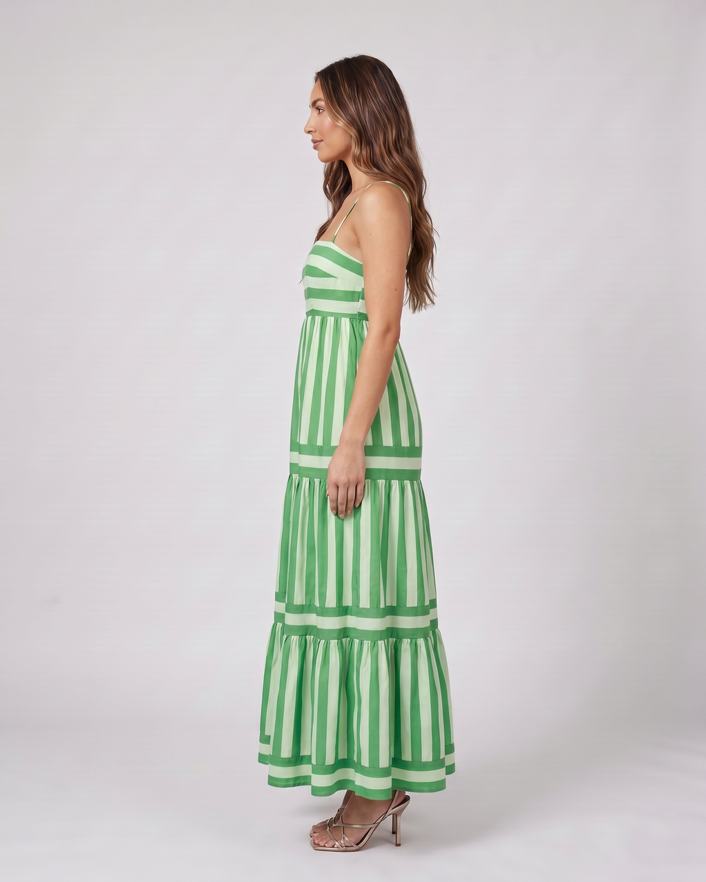 Side view of green striped spaghetti strap maxi dress