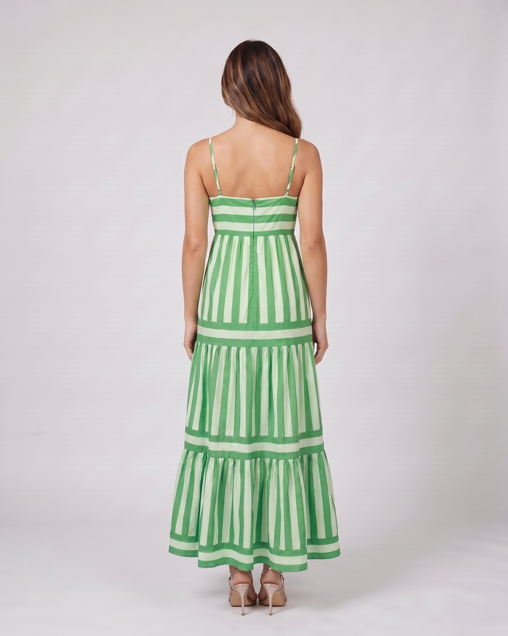 Back view of green striped spaghetti strap maxi dress showing solid back with invisible zipper closure
