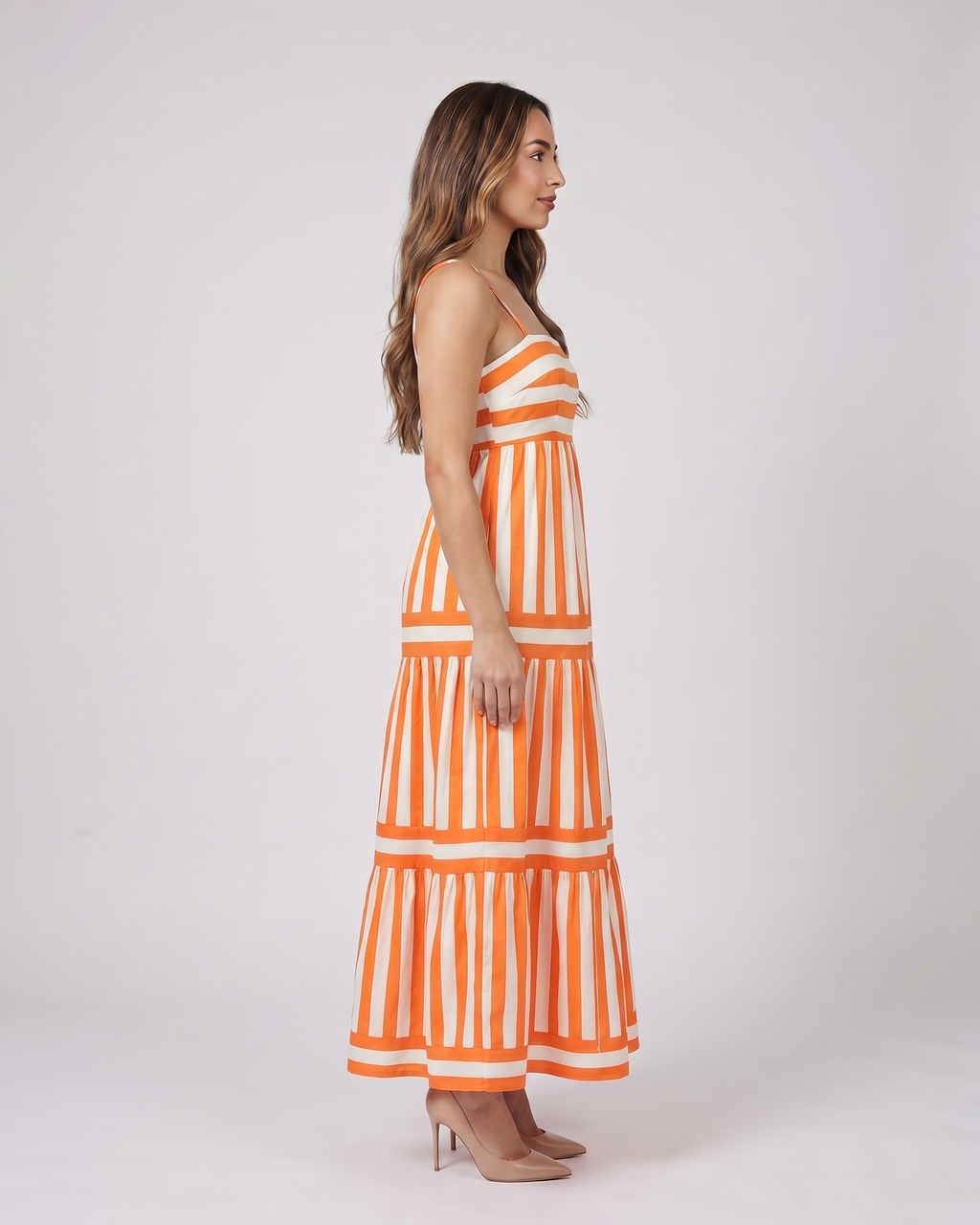 Side view of orange striped spaghetti strap maxi dress