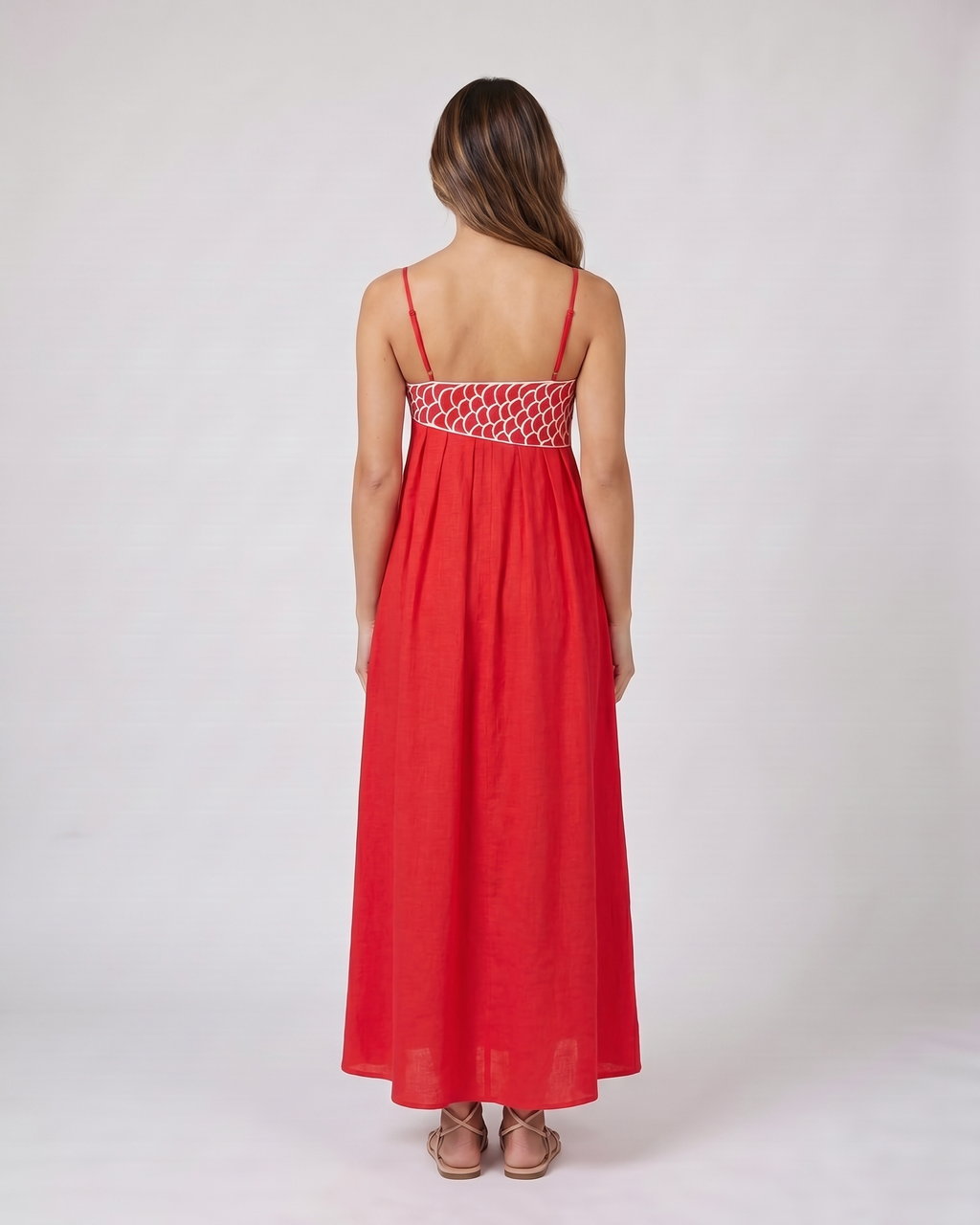 Back view of red sweetheart fish print maxi dress showing solid back with an embroidered waistband and side zipper closure