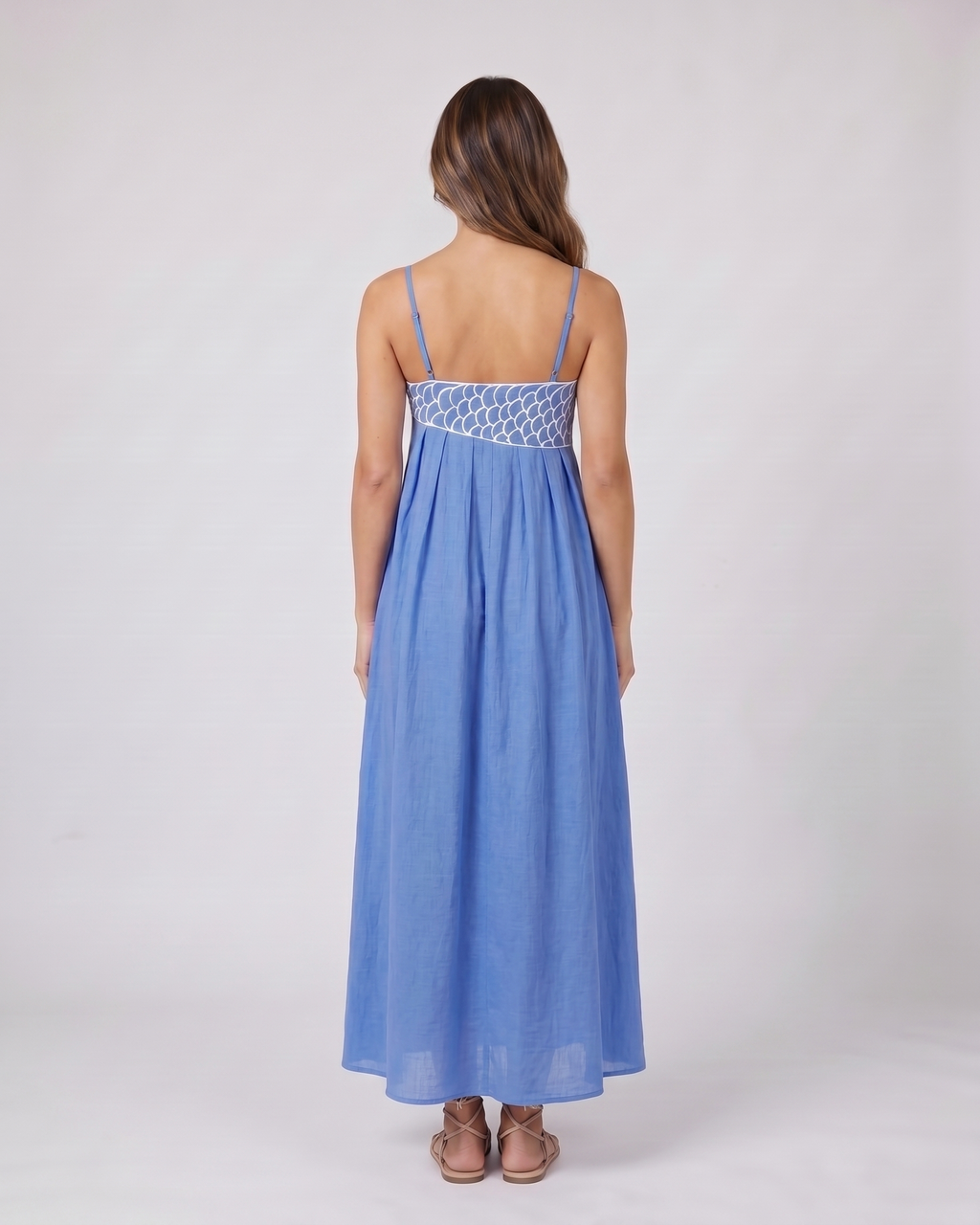 Back view of blue sweetheart fish print maxi dress showing solid back with an embroidered waistband and side zipper closure