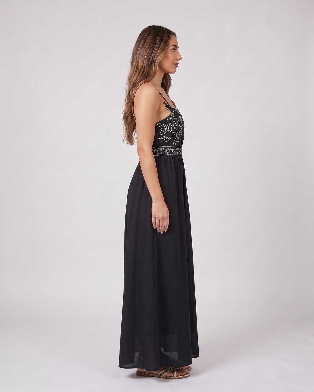 Side view of black sweetheart fish print maxi dress