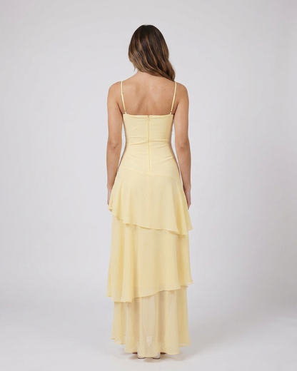 Back view of yellow sweetheart spaghetti strap tiered maxi dress showing solid, concealed zipper closure, spaghetti strap