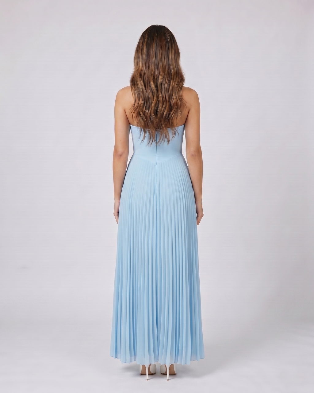 Back view of sky blue sweetheart strapless pleated maxi dress showing solid back with center zip closure