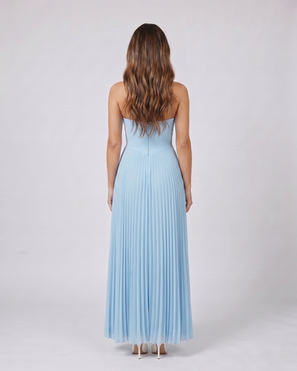 Back view of sky blue sweetheart strapless pleated maxi dress showing solid back with center zip closure