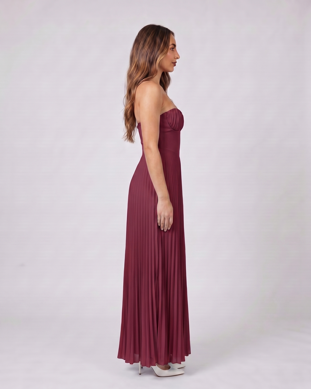Side view of claret sweetheart strapless pleated maxi dress
