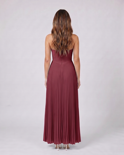 Back view of claret sweetheart strapless pleated maxi dress showing solid back with center zip closure