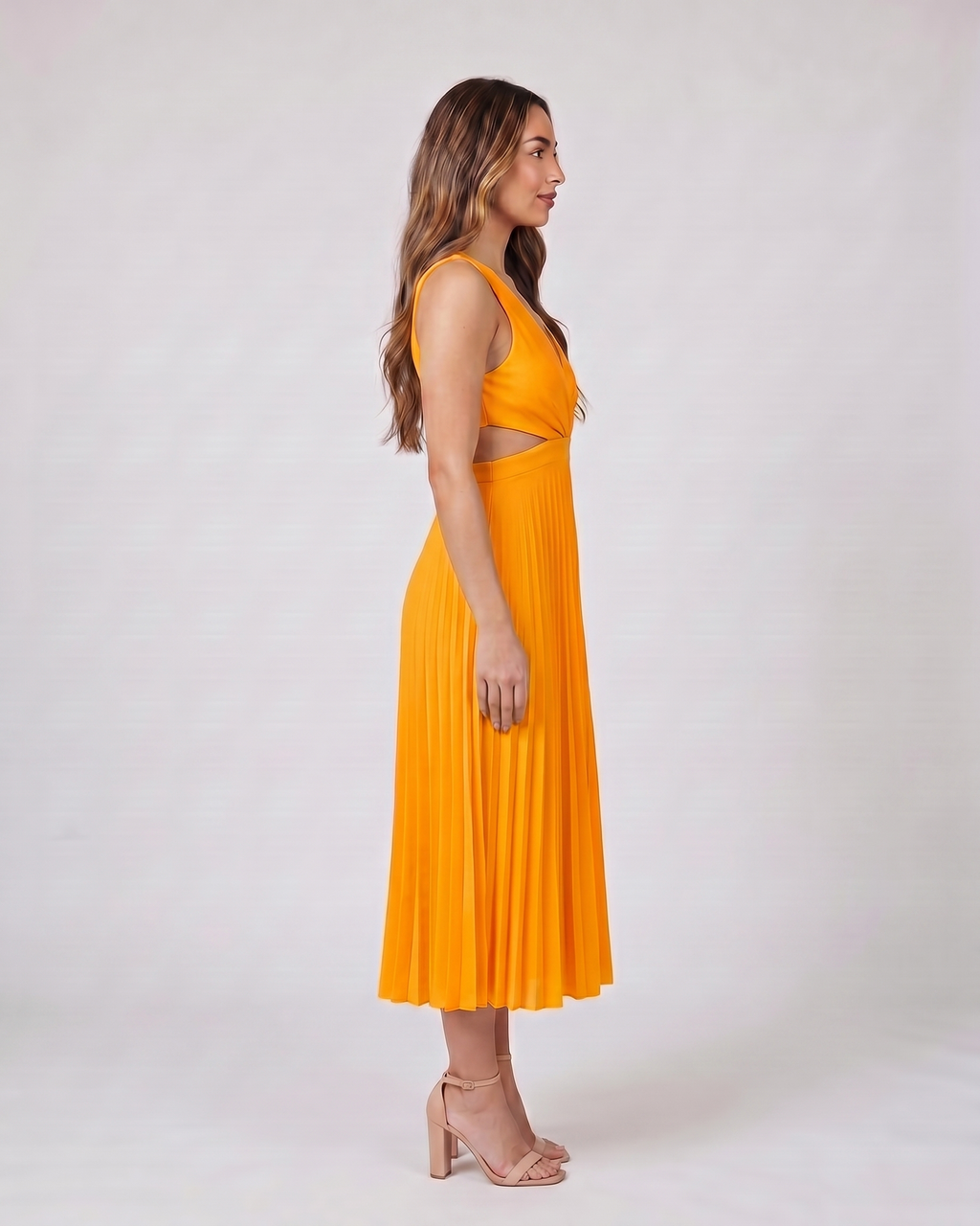 Side view of orange v neck cutout pleated midi dress