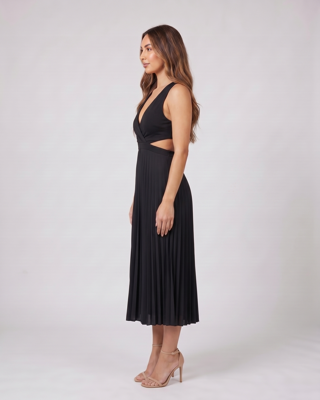Side view of black v neck cutout pleated midi dress