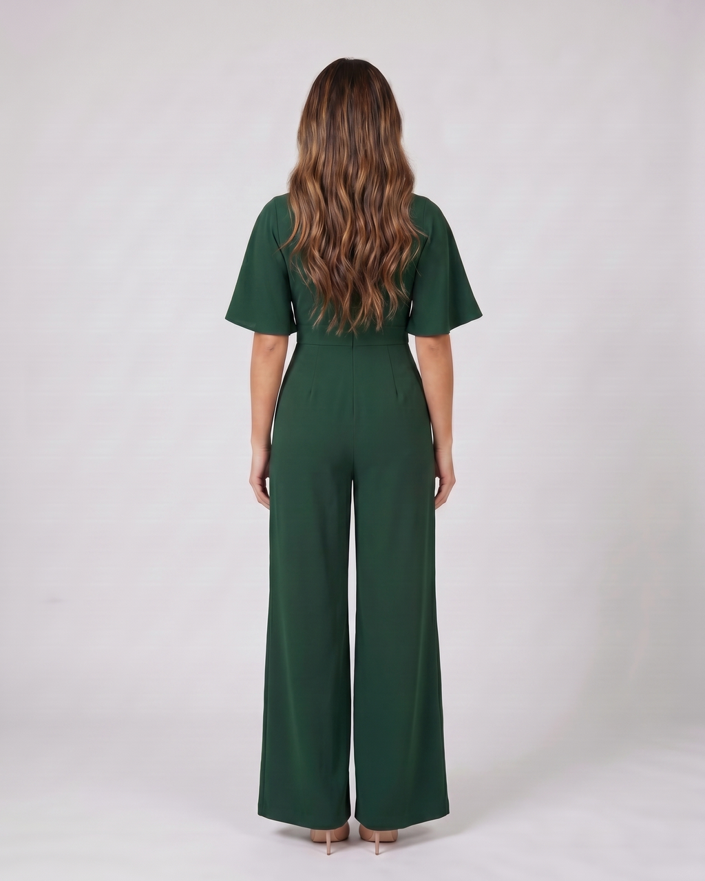 Back view of green v neck flutter sleeve wide leg jumpsuit showing solid back