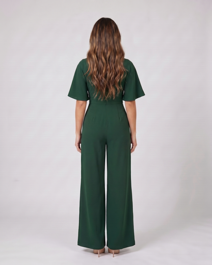 Back view of green v neck flutter sleeve wide leg jumpsuit showing solid back