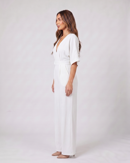 Side view of white v neck flutter sleeve wide leg jumpsuit
