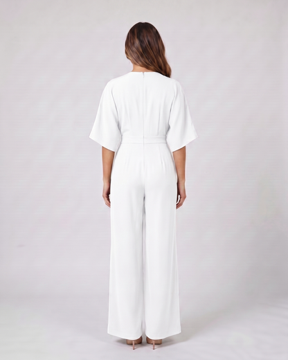Back view of white v neck flutter sleeve wide leg jumpsuit showing solid back
