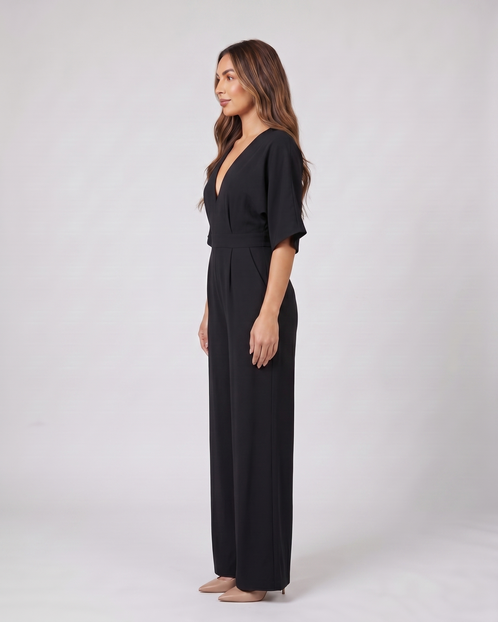 Side view of black v neck flutter sleeve wide leg jumpsuit