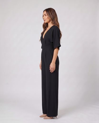 Side view of black v neck flutter sleeve wide leg jumpsuit