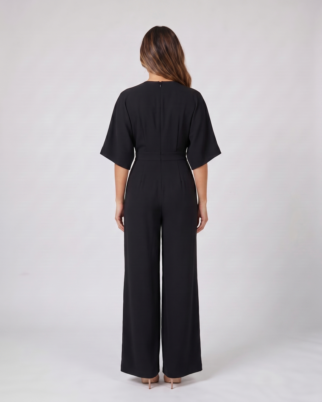 Back view of black v neck flutter sleeve wide leg jumpsuit showing solid back