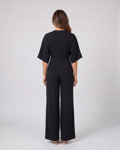 Back view of black v neck flutter sleeve wide leg jumpsuit showing solid back
