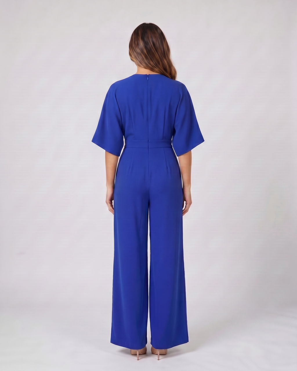 Back view of blue v neck flutter sleeve wide leg jumpsuit showing solid back