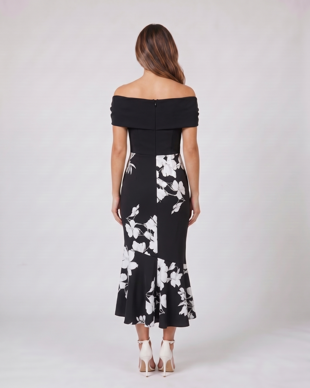 Back view of black wedding guest floral off shoulder midi dress showing solid back with zipper closure