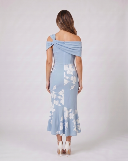 Back view of blue wedding guest floral off shoulder midi dress showing solid back with zipper closure