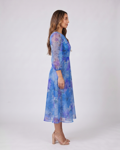Side view of blue wedding guest floral puff sleeve midi dress