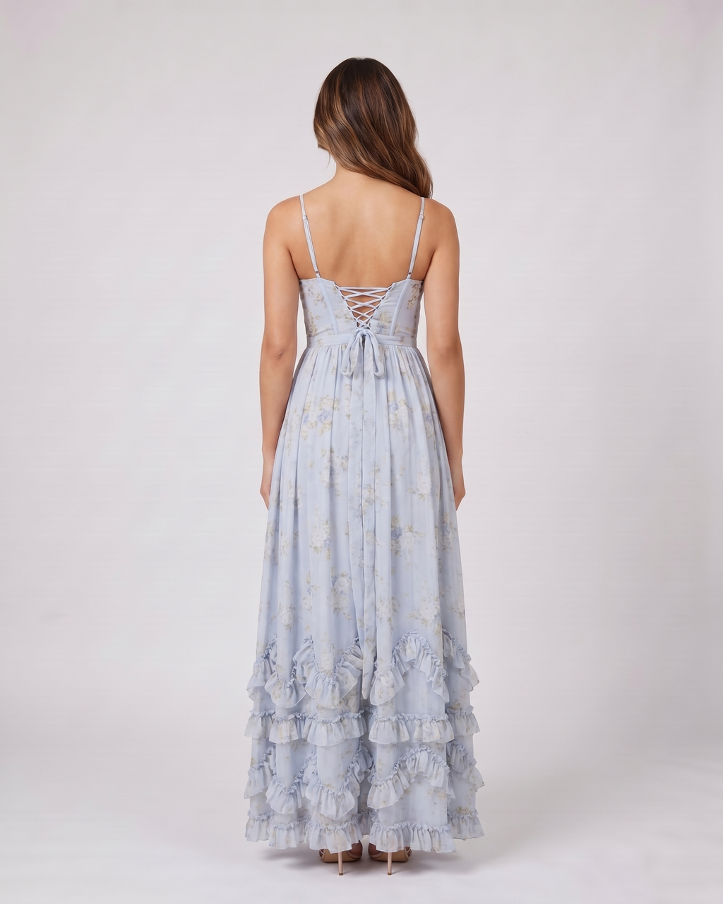 Back view of blue wedding guest floral sweetheart maxi dress showing lace-up corset back