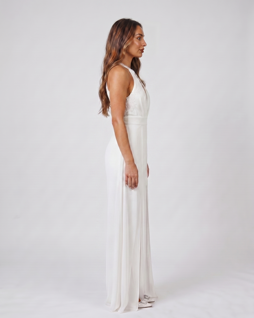 Side view of white wedding guest halter v neck wide leg jumpsuit