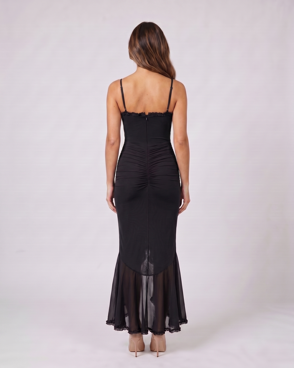Back view of black wedding guest ruched sweetheart maxi dress showing solid back with center zipper closure
