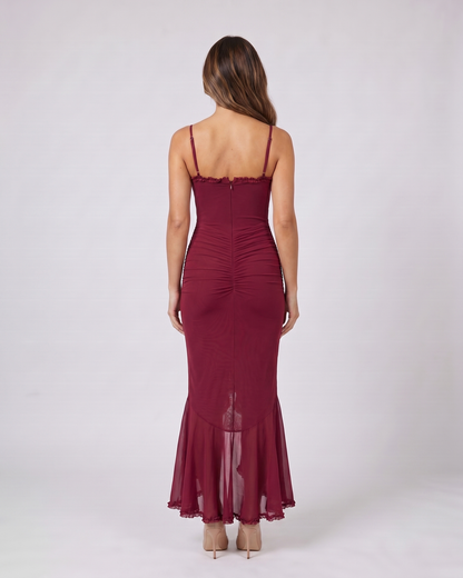 Back view of burgundy wedding guest ruched sweetheart maxi dress showing solid back with center zipper closure