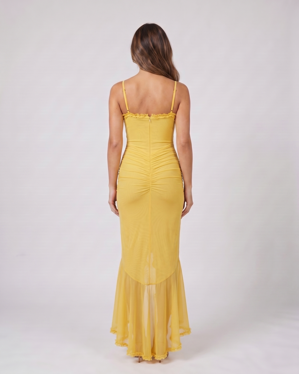 Back view of yellow wedding guest ruched sweetheart maxi dress showing solid back with center zipper closure