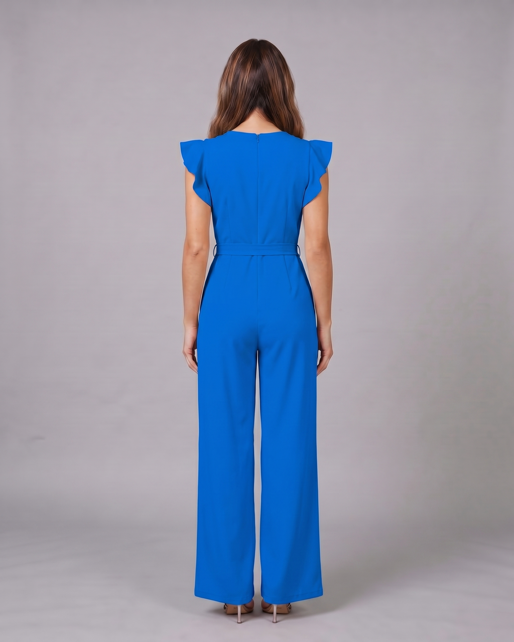 Back view of blue wedding guest ruffle sleeve wide leg jumpsuit showing solid back with invisible zipper closure