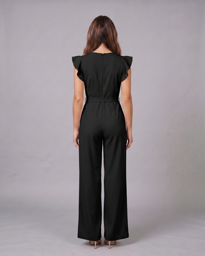 Back view of black wedding guest ruffle sleeve wide leg jumpsuit showing solid back with invisible zipper closure