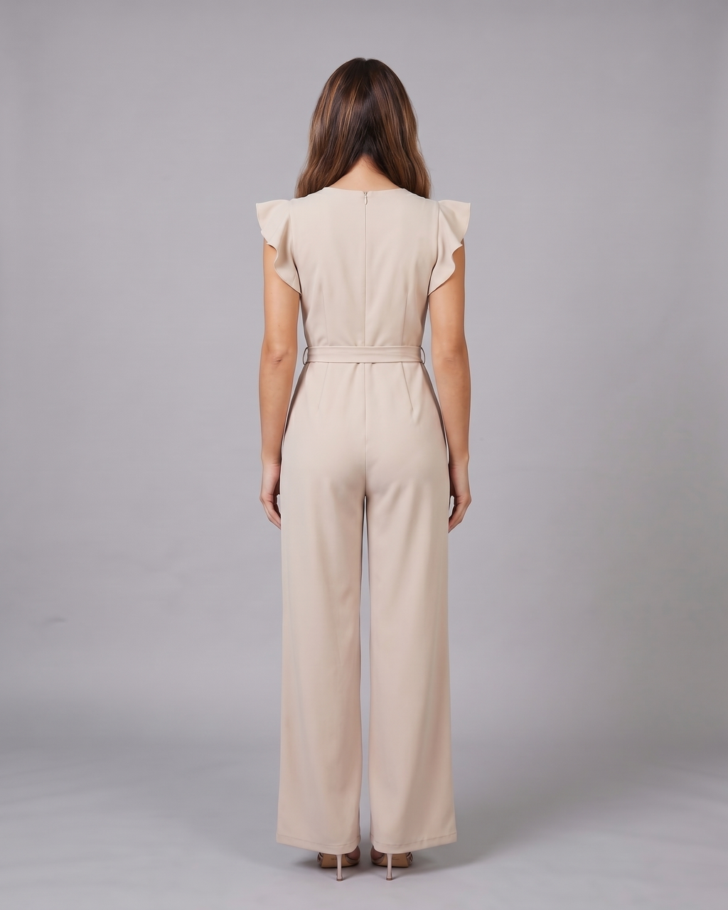 Back view of beige wedding guest ruffle sleeve wide leg jumpsuit showing solid back with invisible zipper closure