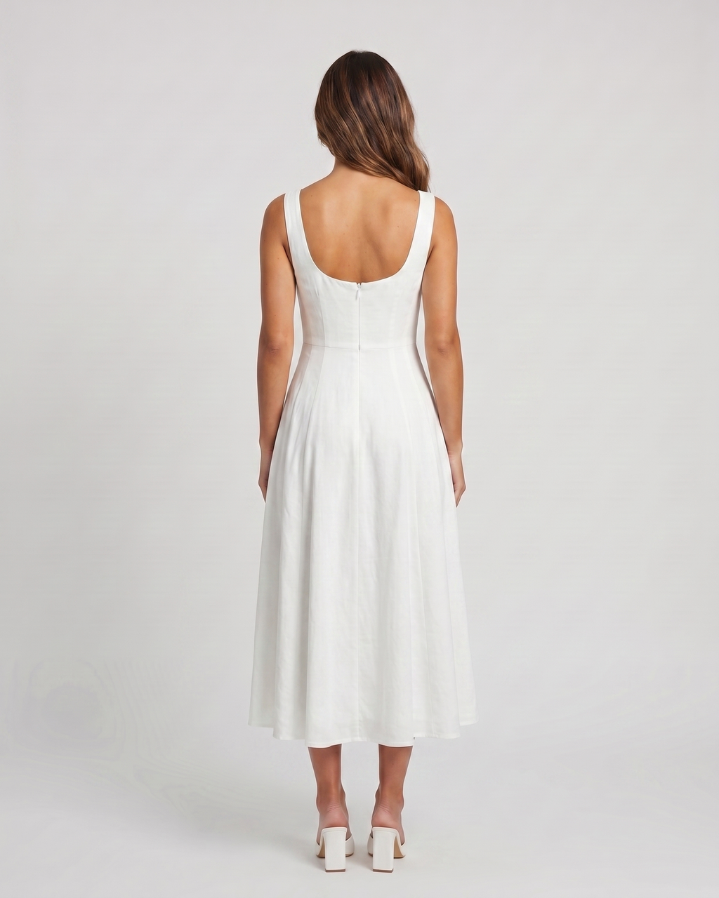 Back view of white wedding guest square neck midi dress showing deep scoop back with concealed zipper closure