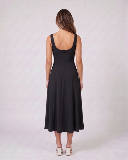 Back view of black wedding guest square neck midi dress showing deep scoop back with concealed zipper closure