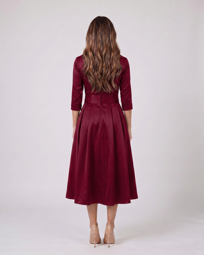 Back view of burgundy wrap v neck 3/4 sleeve with pockets midi dress showing solid back with center seam, concealed zipper closure