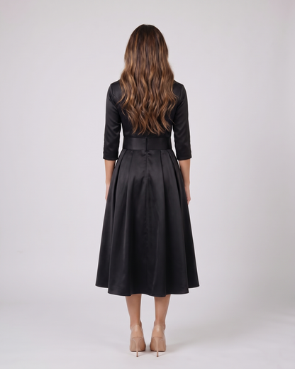 Back view of black wrap v neck 3/4 sleeve with pockets midi dress showing solid back with center seam, concealed zipper closure