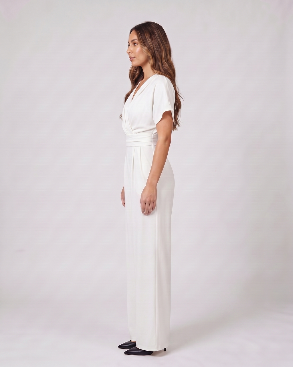 Side view of white cocktail v neck flutter sleeve wide leg jumpsuit
