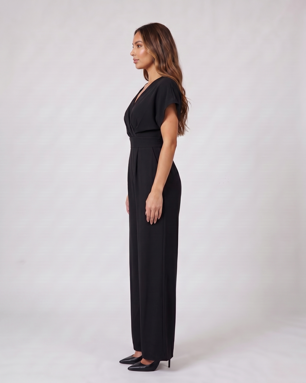 Side view of black cocktail v neck flutter sleeve wide leg jumpsuit