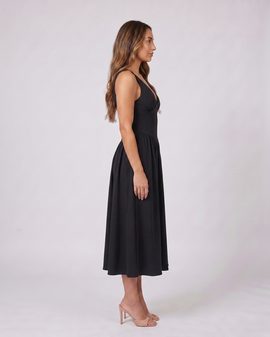 Side view of black women's wedding guest deep v neck midi a line dress